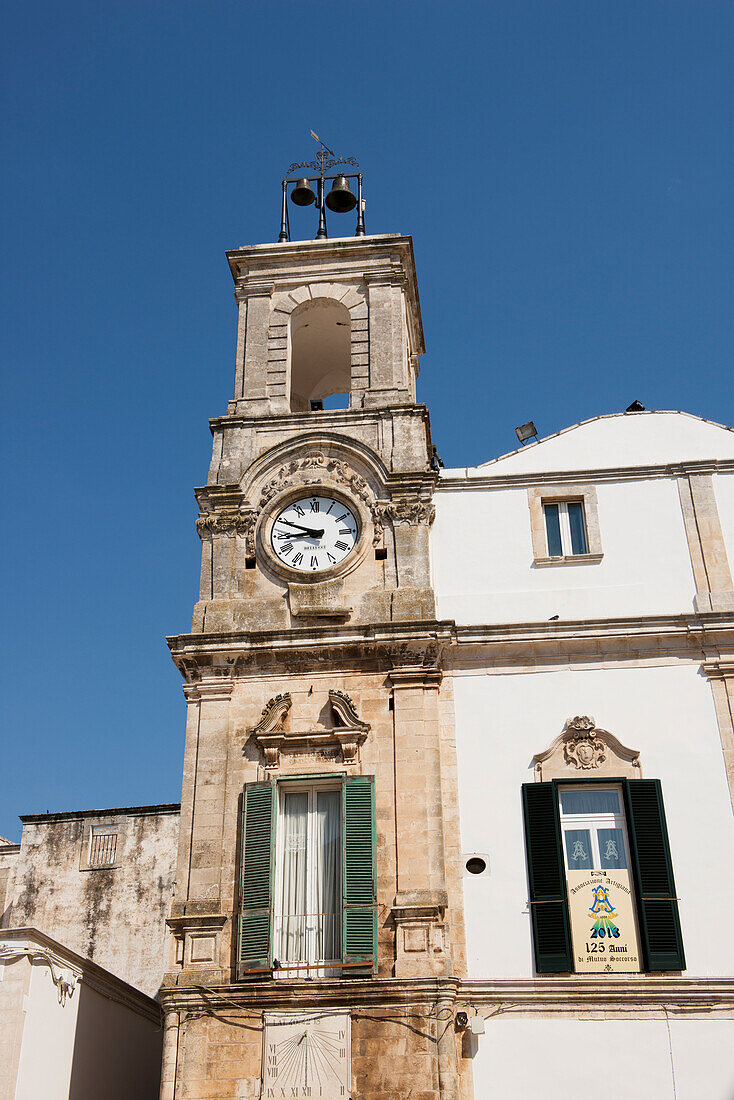 Traditionelle apulische Architektur mit alter Uhr und grünen hölzernen Fensterläden, Martina Franca, Apulien, Italien