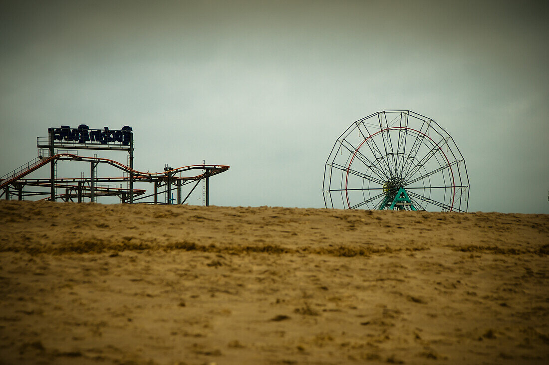 Winter On A Deserted Beach With A Closed Funfair In The Background,Skegness,Lincolnshire,England