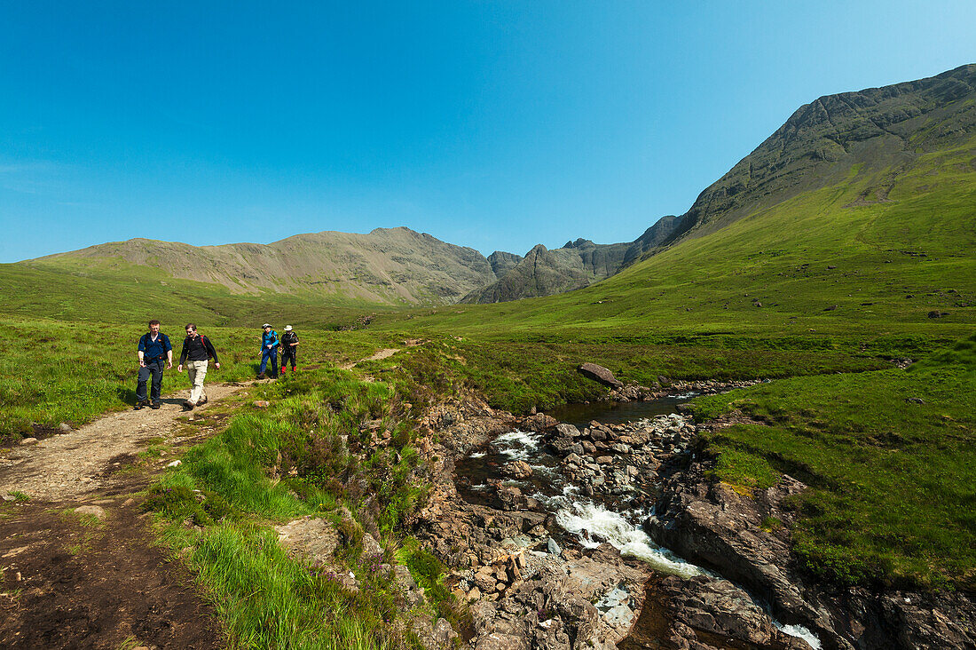 Walkers Going Past One Of The Fairy Pools In Coire Na Creiche,Black Cuillin,Isle Of Skye,Scotland