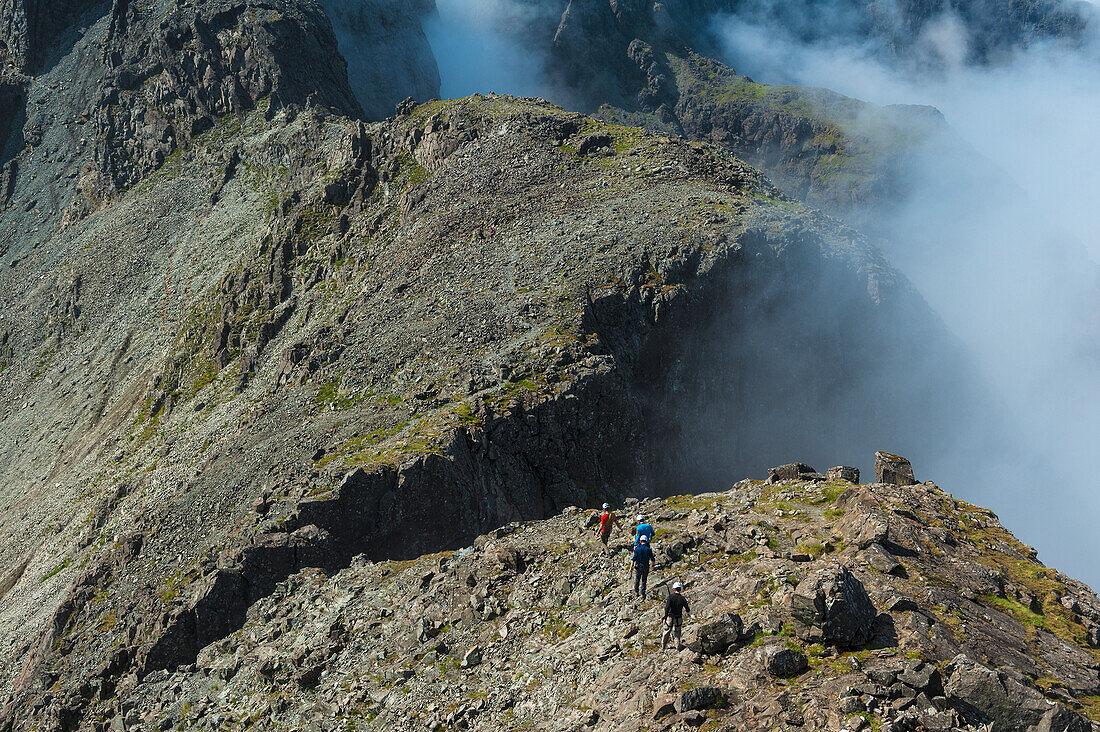 Walkers Going Along Ridge Above Clouds In The Black Cuillin,Isle Of Skye,Scotland