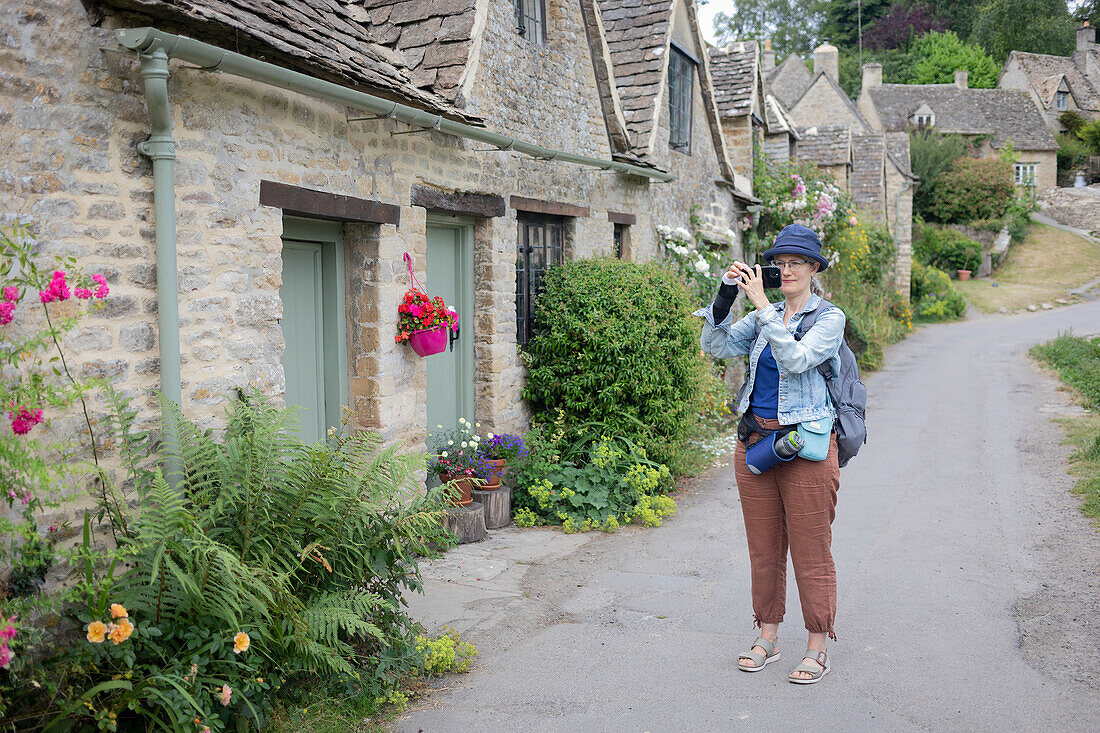 Mature woman uses her smart phone to take photographs while travelling in the UK,United Kingdom