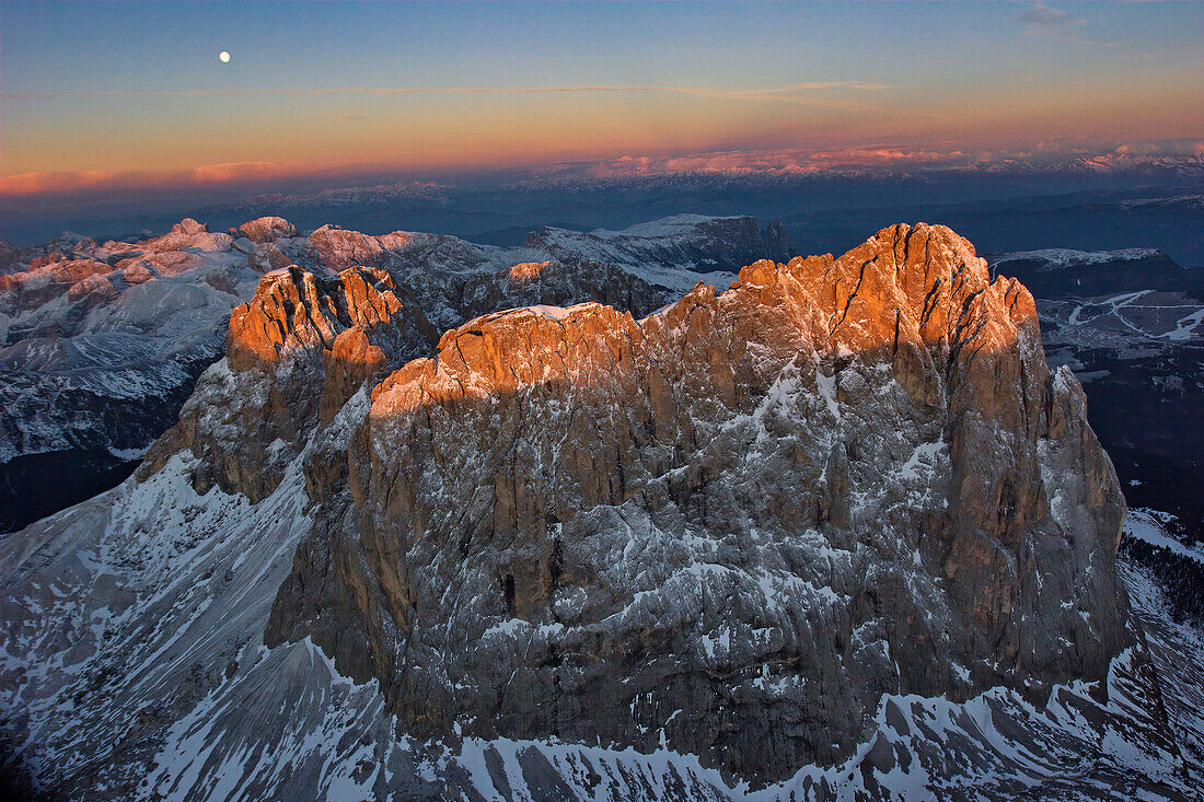 Aerial view of the Dolomite Mountains at sunrise and a visible moon,Ortisei,Italy