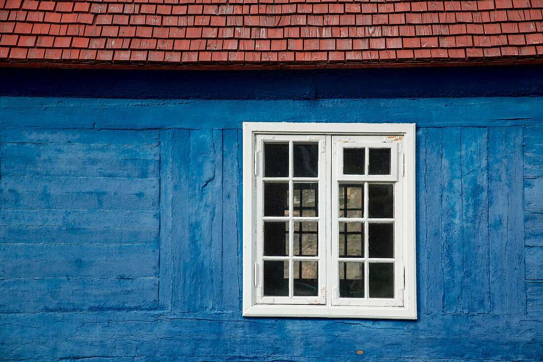 Old wooden window in a blue painted log building,Sisimiut,Greenland