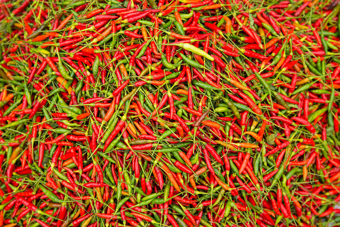 Abundance of red and green peppers on display for sale in a street market in Luang Pragang,Luang Prabang,Laos