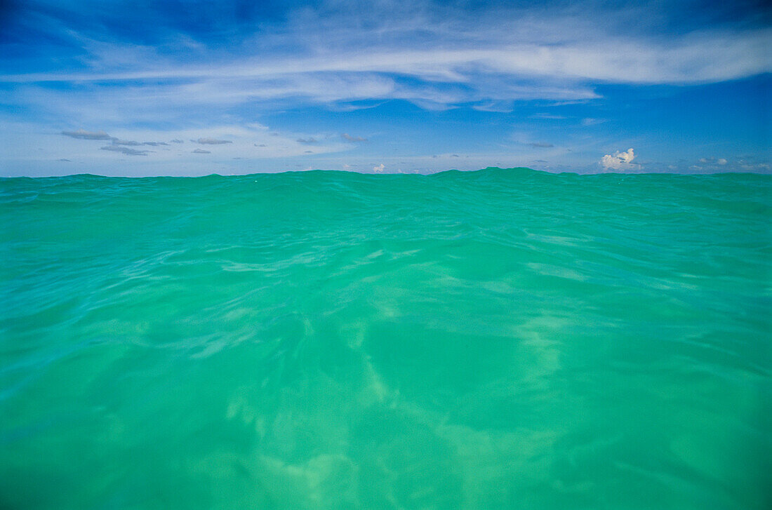 Clear blue water and wispy clouds along a Caribbean beach,Cancun,Mexico