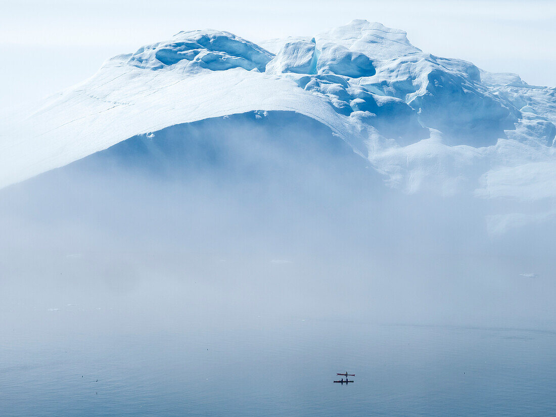 Two kayaks amongst icebergs in Disko Bay,Ilulissat,Greenland