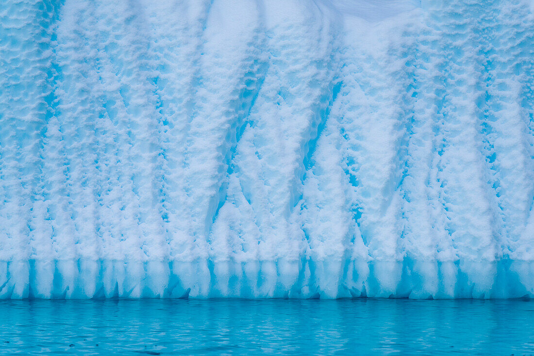 Close-up detail of an iceberg surface and water's edge on the west side of the Antarctic peninsula,Antarctica