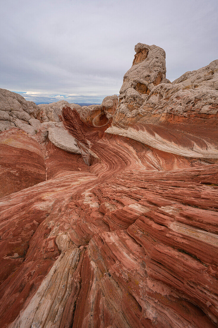 Scenic view of swirling patterns and hilly,rock formations under a cloudy sky,forming part of the alien landscape of amazing lines,contours and shapes in the wondrous area known as White Pocket,situated in Arizona,Arizona,United States of America