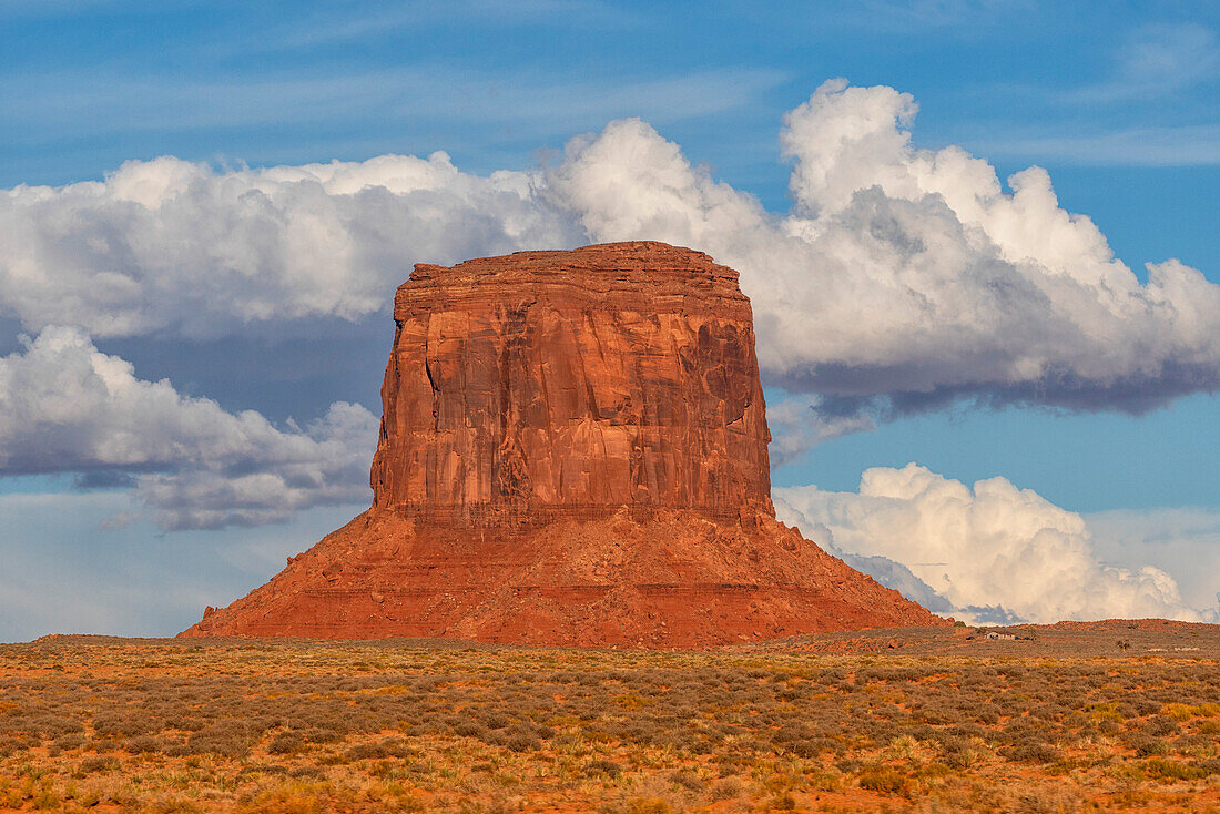 Merrick Butte, eine Felsformation im Monument Valley, Arizona.  Die roten Felsen leuchten bei Sonnenuntergang, wenn das Licht auf sie trifft, Arizona, Vereinigte Staaten von Amerika