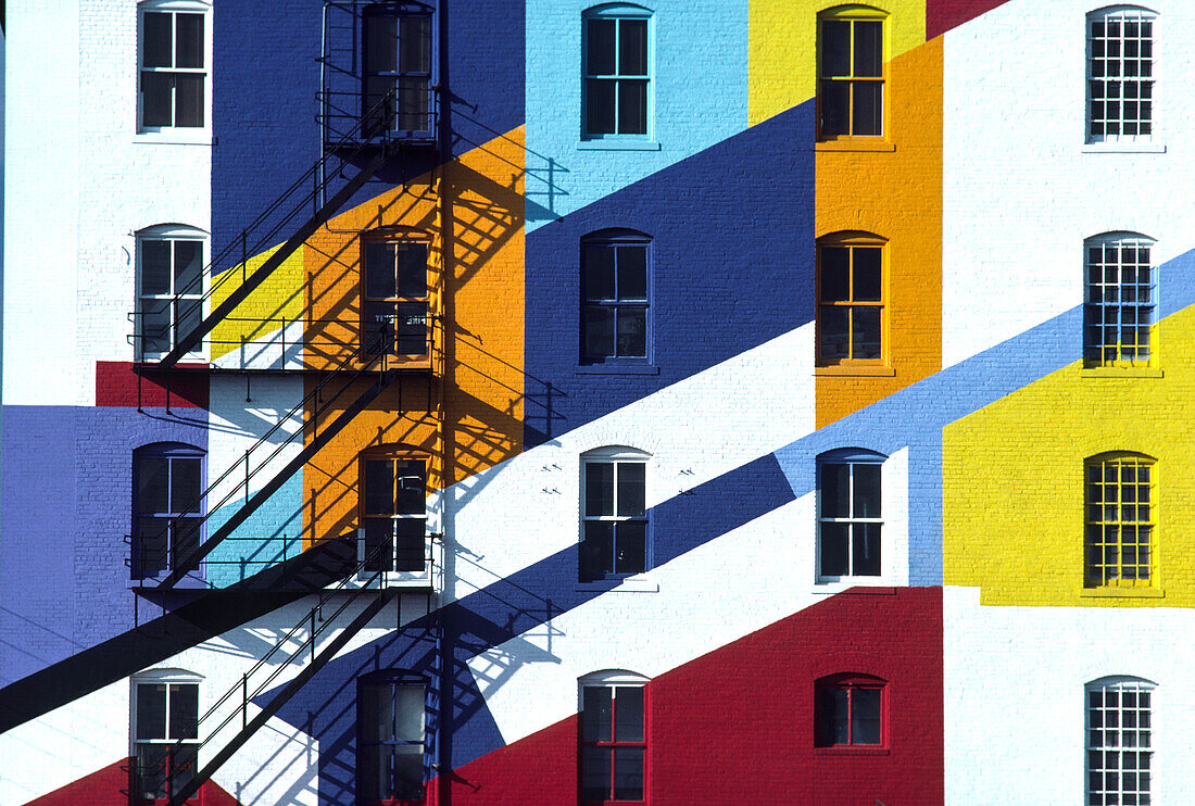 Fire escape on a colorfully painted building,New York City,New York,United States of America