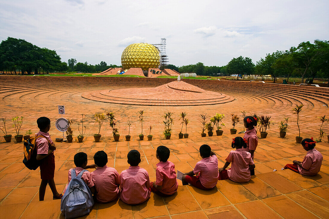 School kids visit Auroville,Utopian 'city with a soul',with a view of Matri Mandir in the distance,Auroville,Tamil Nadu,India