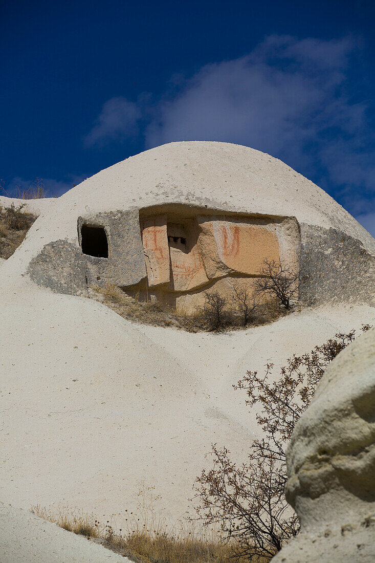 Close-up of domed,Cave House against a bright blue sky in the town of Goreme in Pigeon Valley,Cappadocia Region,Nevsehir Province,Turkey