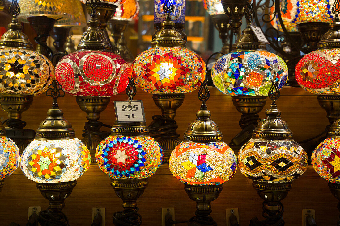 Lamps for sale,colorful,globular pendant lights illuminated and hanging in a shop on display in the Spice Bazaar in the Fatih District,Istanbul,Turkey