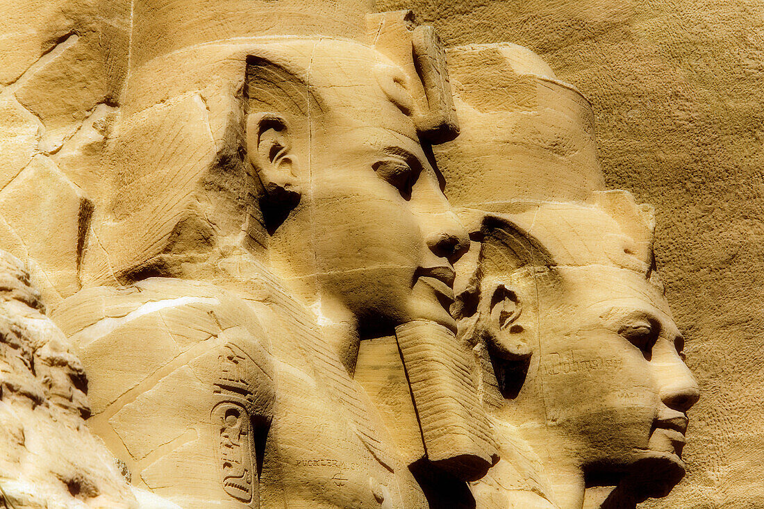 Close-up of two of the Ramses II statues carved out of the mountainside at the front of the Great Sun Temple of Abu Simbel,Abu Simbel,Nubia,Egypt