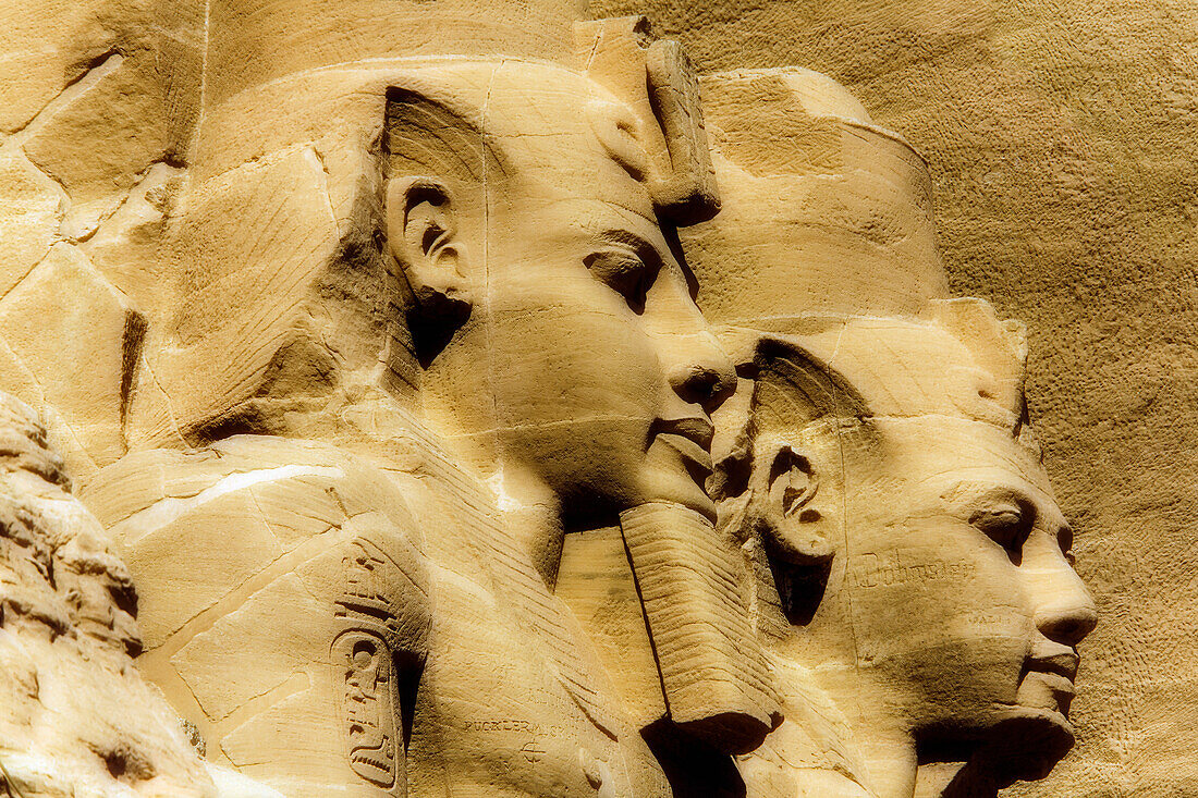 Nahaufnahme von zwei Statuen von Ramses II., die aus dem Berghang vor dem Großen Sonnentempel von Abu Simbel herausgearbeitet wurden, Abu Simbel, Nubien, Ägypten