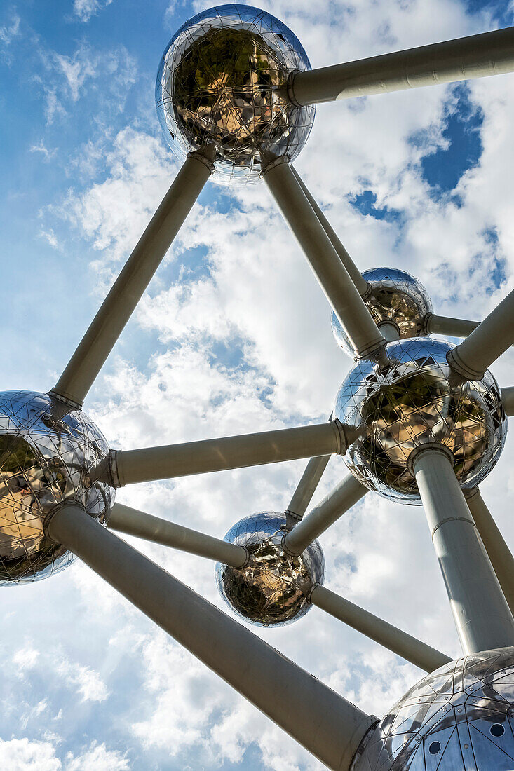 Large stainless steel art structure in the shape of an atom with blue sky and sunburst,Brussels,Belgium