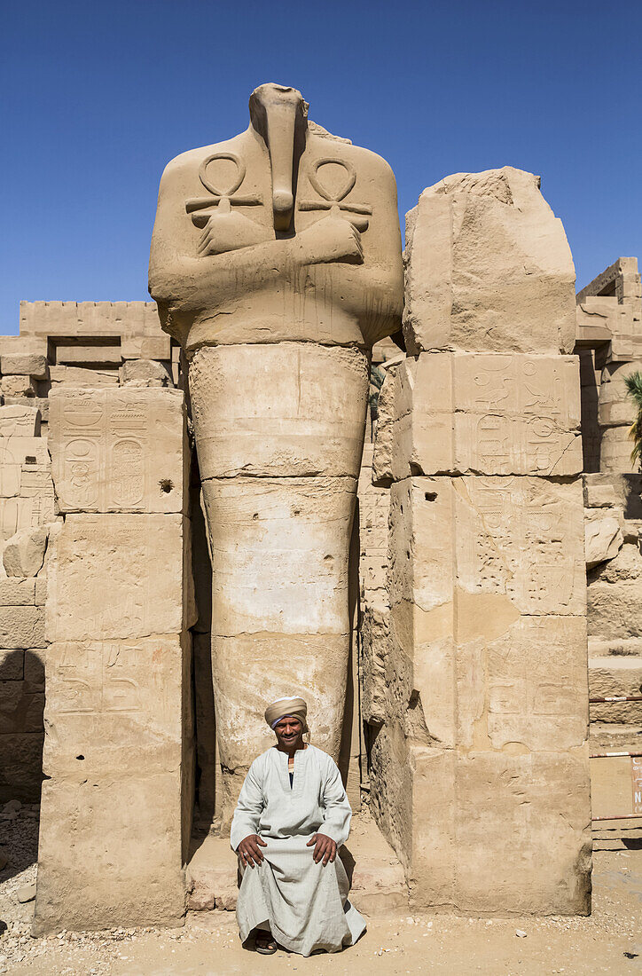 Caretaker,Statue of Headless Pharaoh,Karnak Temple Complex,UNESCO World Heritage Site,Luxor,Egypt