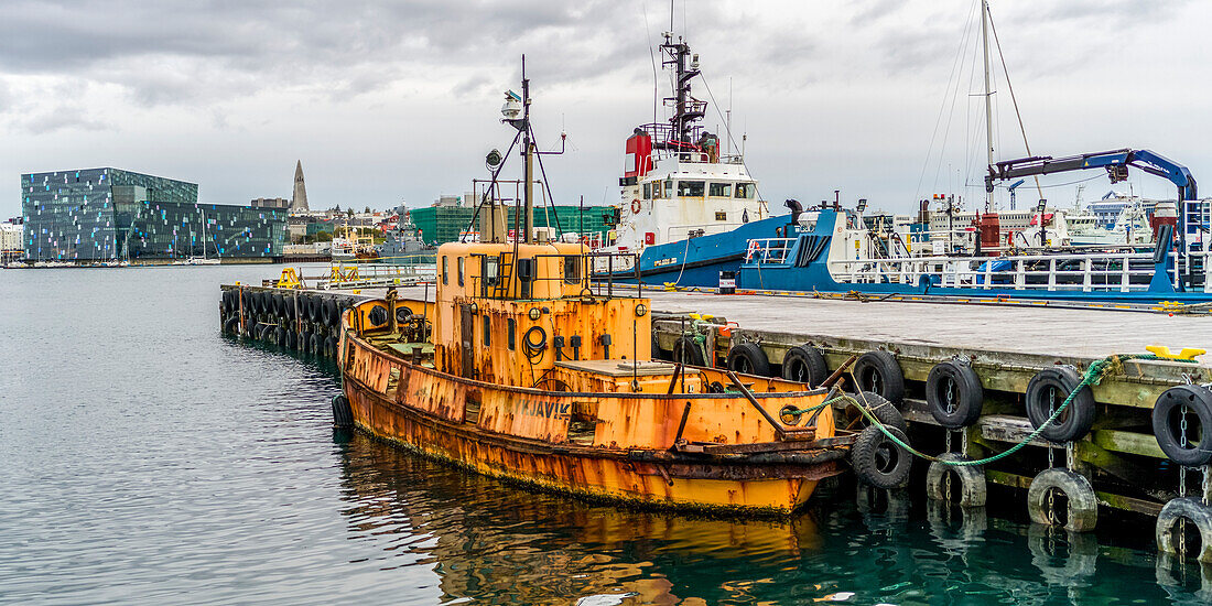 Ships in the harbour of Reykjavik,with a view of Harpa concert hall and conference centre at the waterfront,Reykjavik,Reykjavik,Iceland