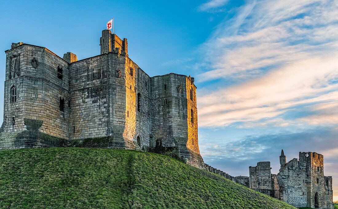 Winter sun setting on the medieval,Warkworth Castle in the village of Warworth,Northumberland,England,United Kingdom