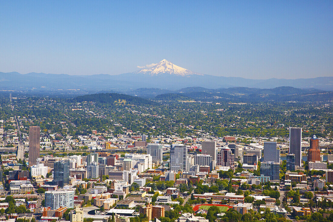 Cityscape of Portland,Oregon with the Willamette River and a view of Mount Hood and the Cascade Range in the distance,Portland,Oregon,United States of America