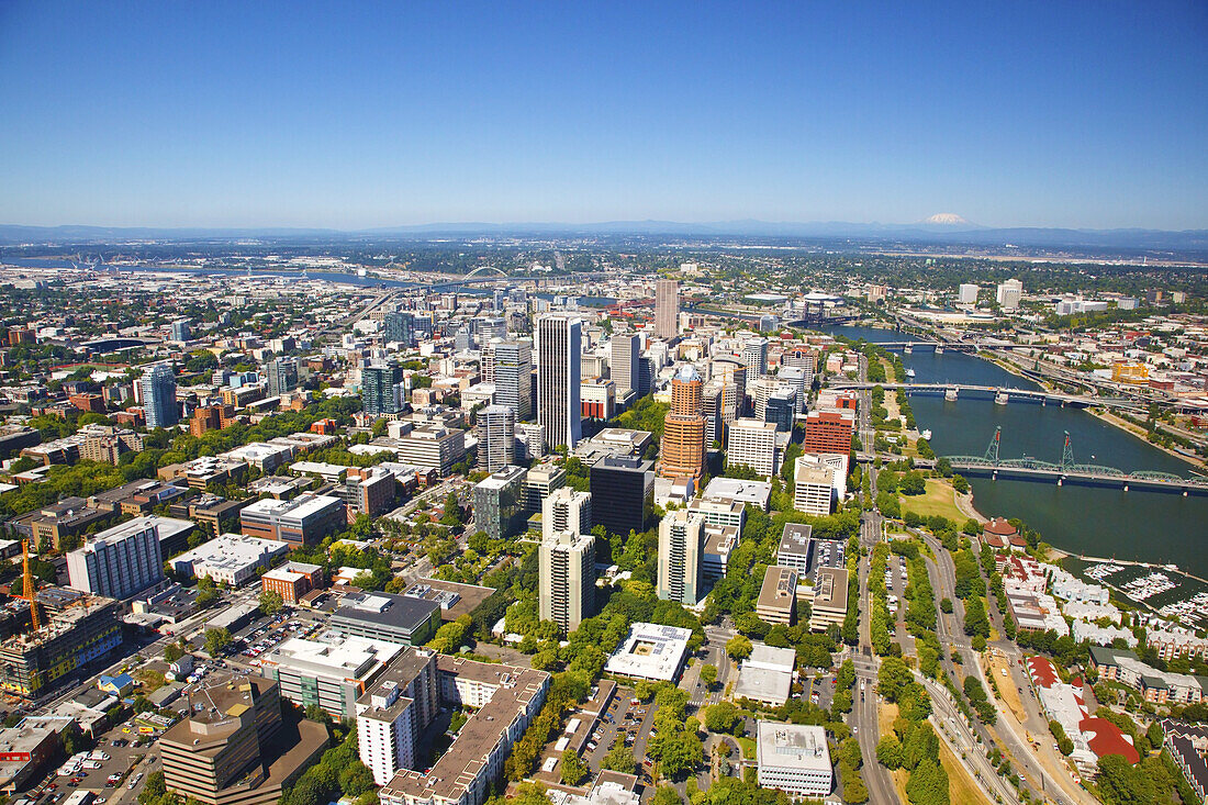 Cityscape of Portland,Oregon with bridges crossing the Willamette River and a view of Mount Saint Helens and the Cascade Range in the distance,Portland,Oregon,United States of America