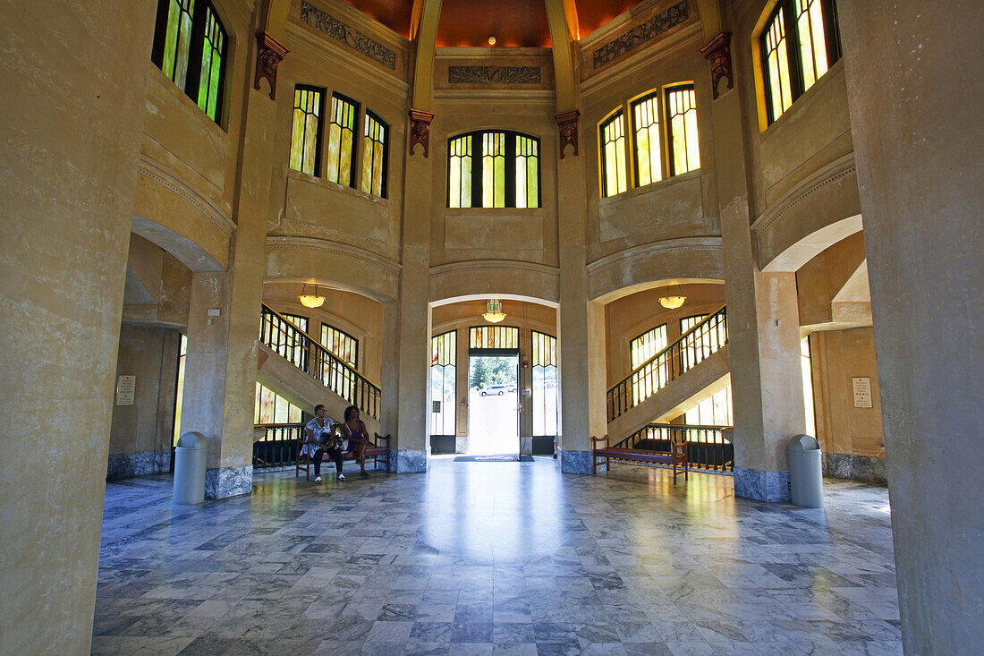 Tourists inside Vista House,a museum on Crown Point in the Columbia River Gorge,which was a comfort station for Oregon pioneers and travellers along the Historic Columbia River Highway,Oregon,United States of America