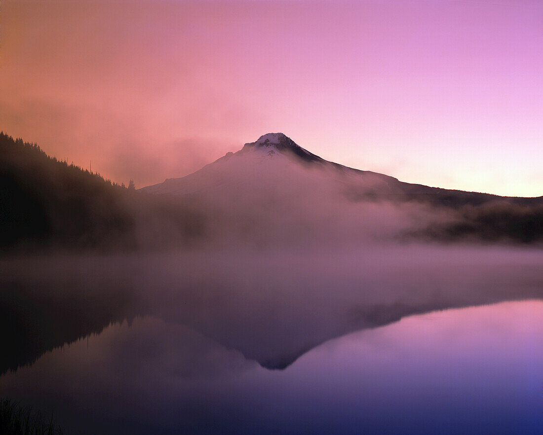 Dramatic glowing pink sunrise over Mount Hood and the mirror image in Trillium Lake,Oregon,United States of America