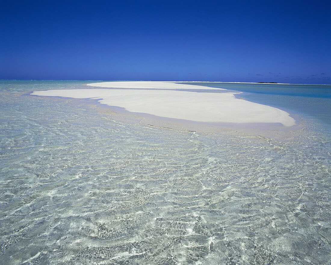 A white sand island surrounded by clear blue water in a tropical lagoon,Cook Islands