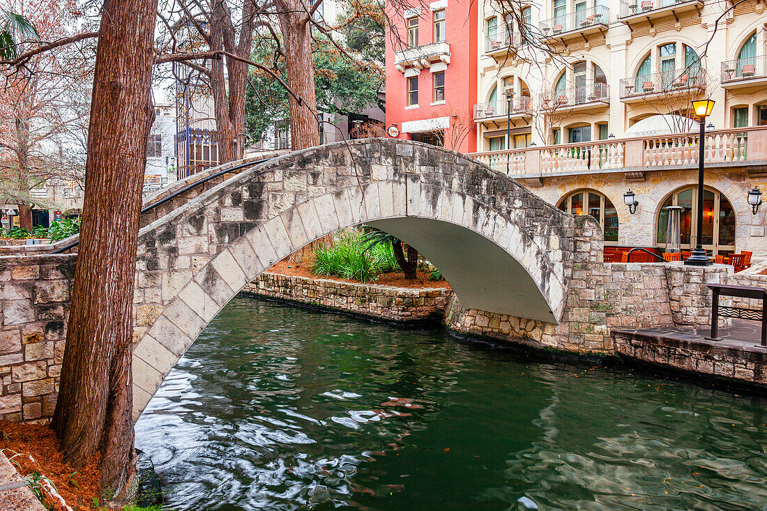 Arched footbridge over the tranquil San Antonio River on the San Antonio River Walk,San Antonio,Texas,United States of America