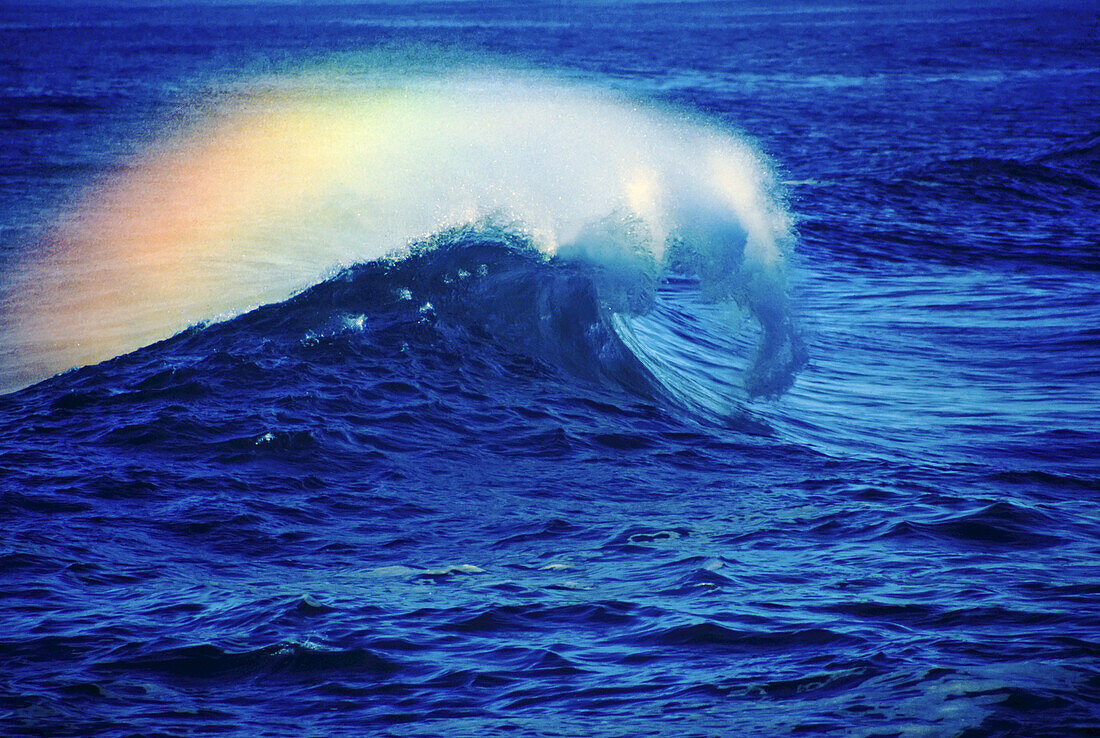 Splashing wave with colours in the mist at the shore of Cape Kiwanda along the Oregon coast in Cape Kiwanda State Natural Area,Oregon,United States of America