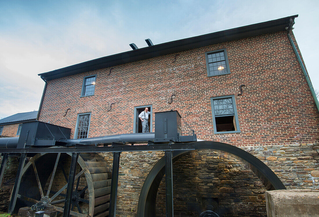 The miller looks on as the wheels turn the water at the Aldie Mill in Loudoun County,Virginia.
