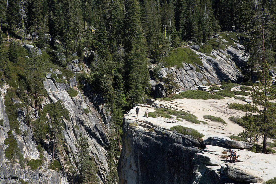 At Taft Point hiking trail peak,several hikers walk and rest on the edge of a cliff that leads to Yosemite Valley.,Yosemite National Park,California