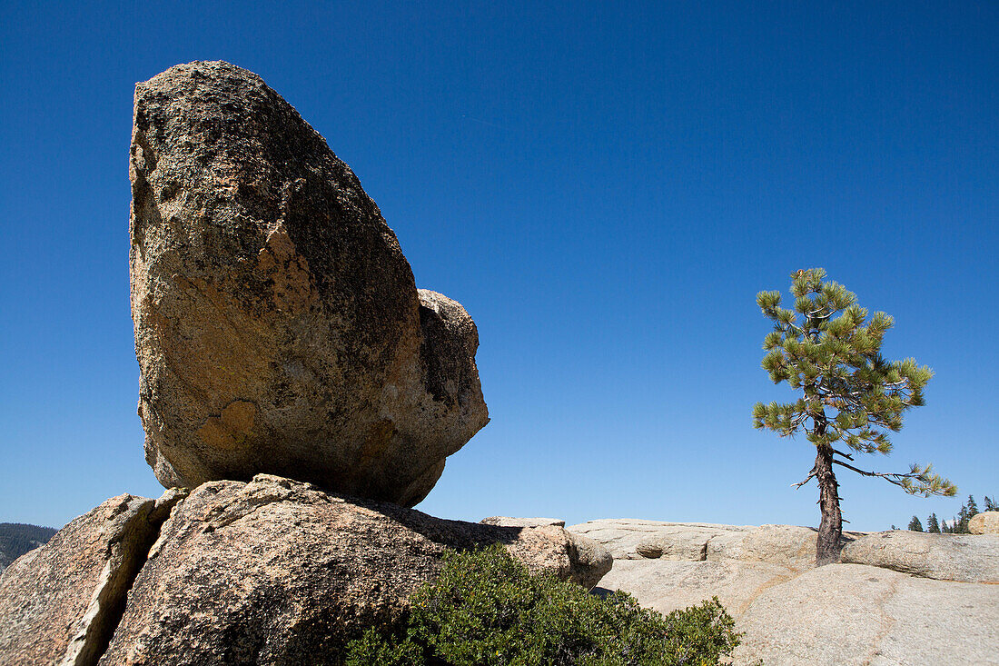 At Taft Point peak,a large rock rests on a ledge that leads to Yosemite Valley below.,Yosemite National Park,California