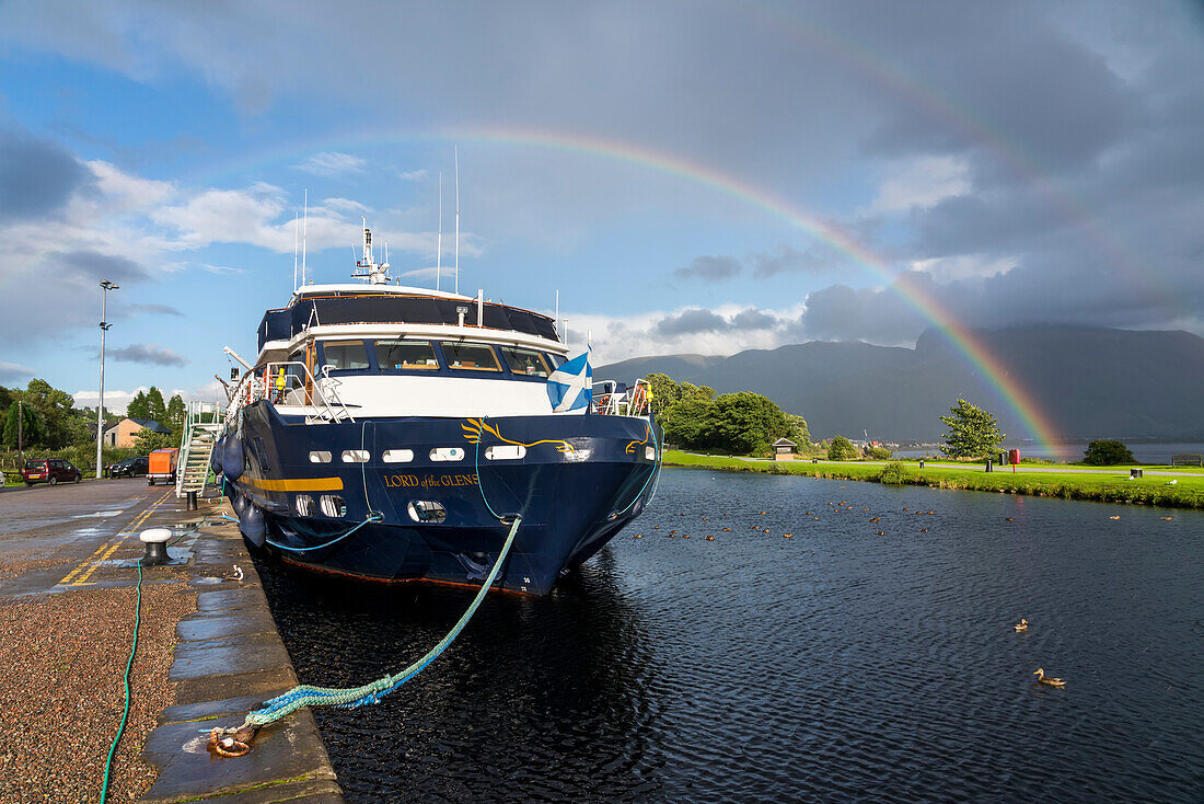 A rainbow spans the sky above a tour boat docked along the Caledonian Canal in Corpach,Scotland,Corpach,Scotland