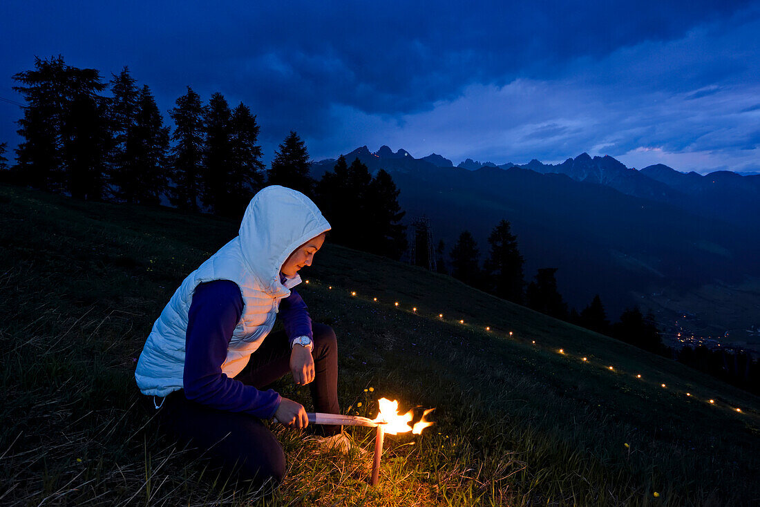 The building and lighting of a sacred heart fire on Elferspitze mountain in the Stubai Valley.,Austria.