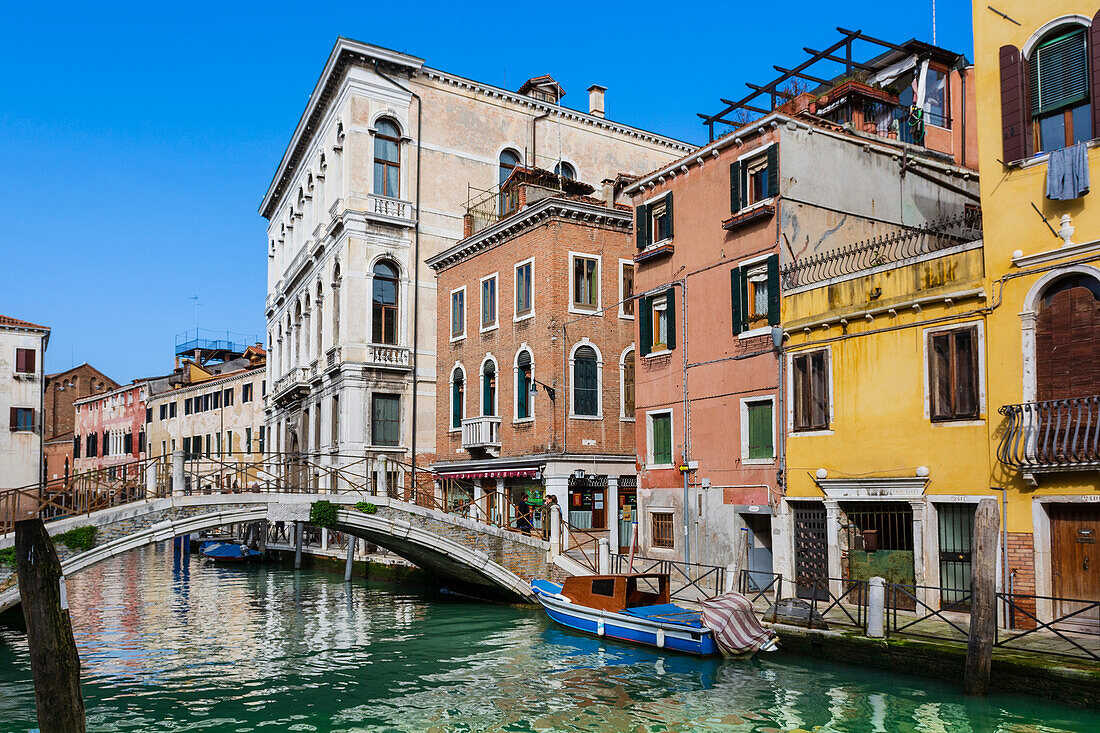 Canal with footbridge and colourful buildings,Venice,Veneto,Italy