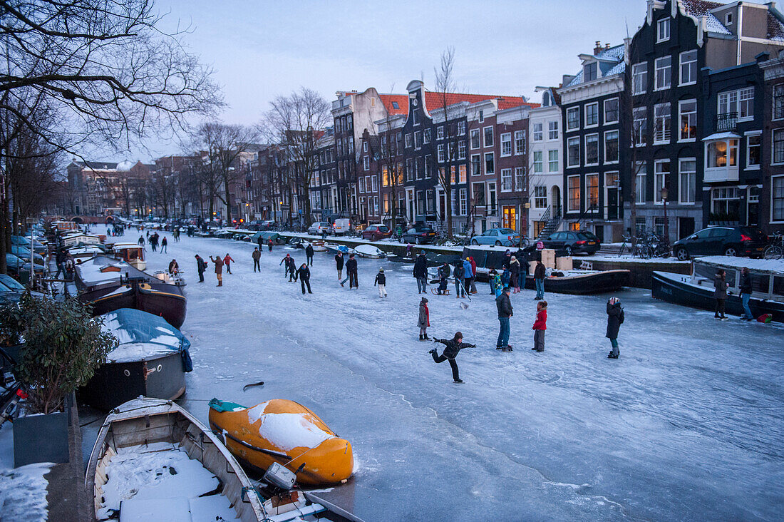 Numerous people ice skating on the canals,Amsterdam,Netherlands