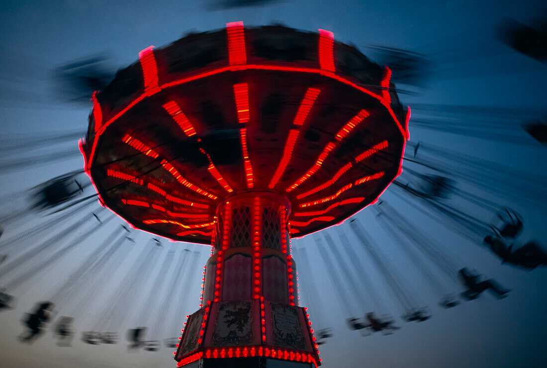 Chair swing ride lit up at dusk at a fair,West Springfield,Massachusetts,United States of America