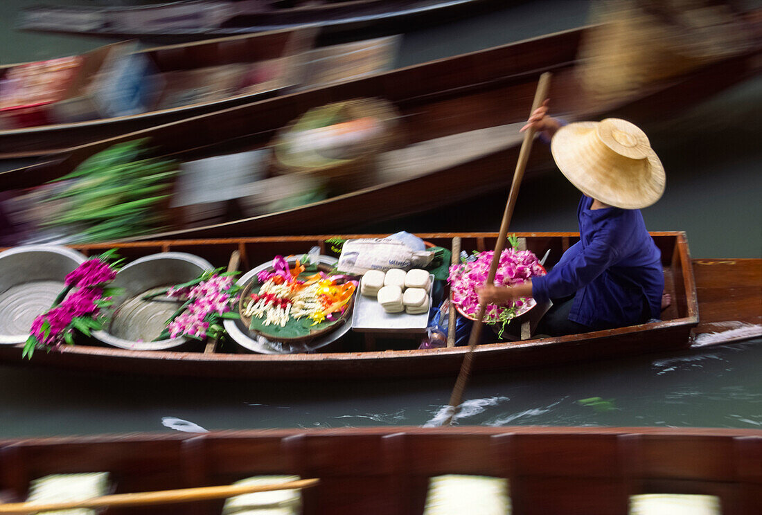 Vendor with flowers and other goods at the floating market in Bangkok,Bangkok,Thailand