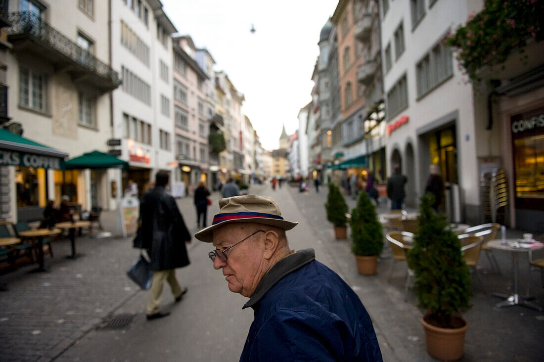 Senior man strolls through a city market in Zurich,Switzerland,Zurich,Switzerland