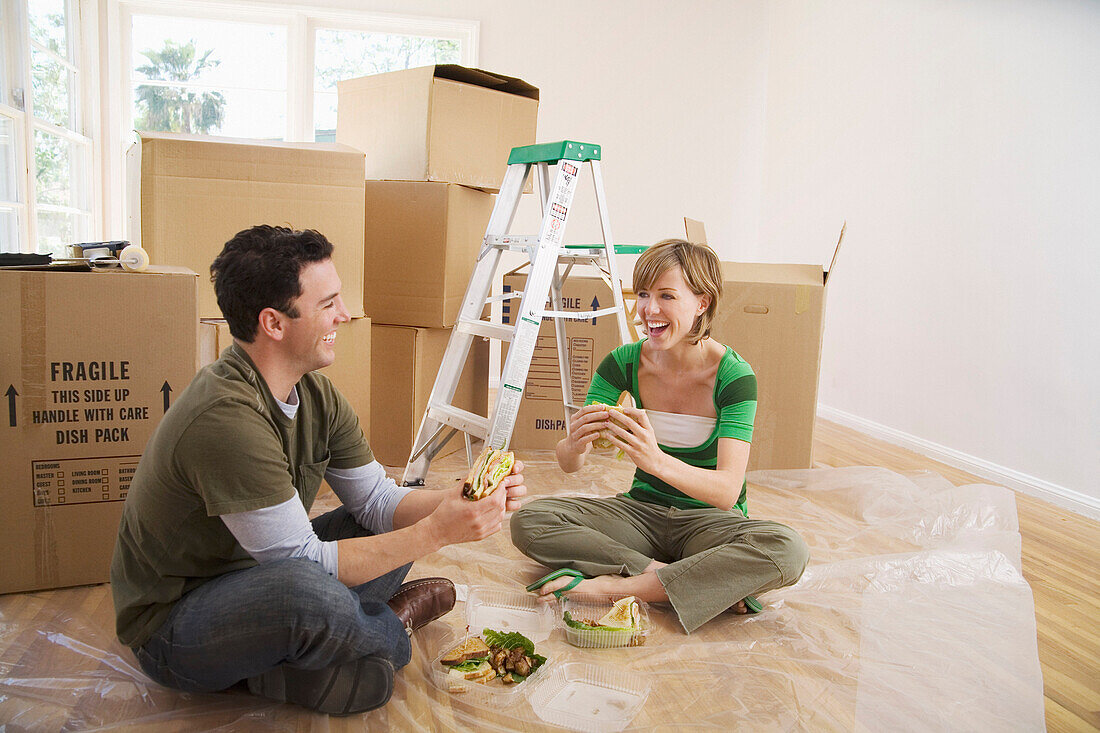 Couple Eating Sandwiches in New Home