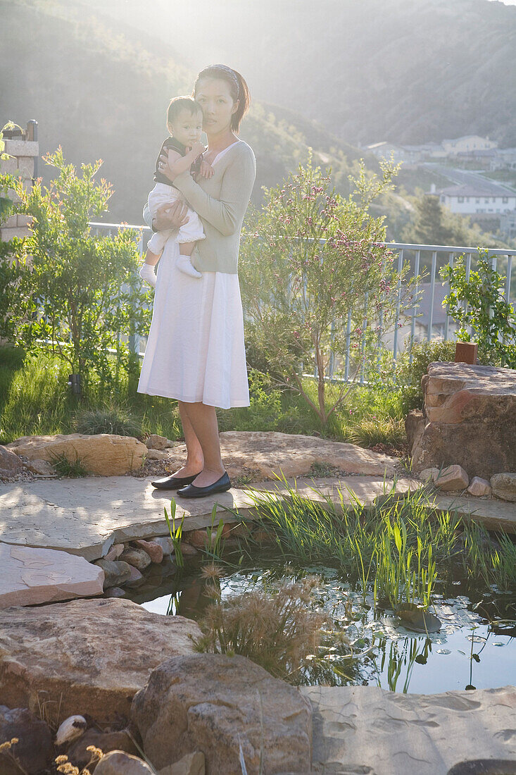 Mother and Child by Garden Pond