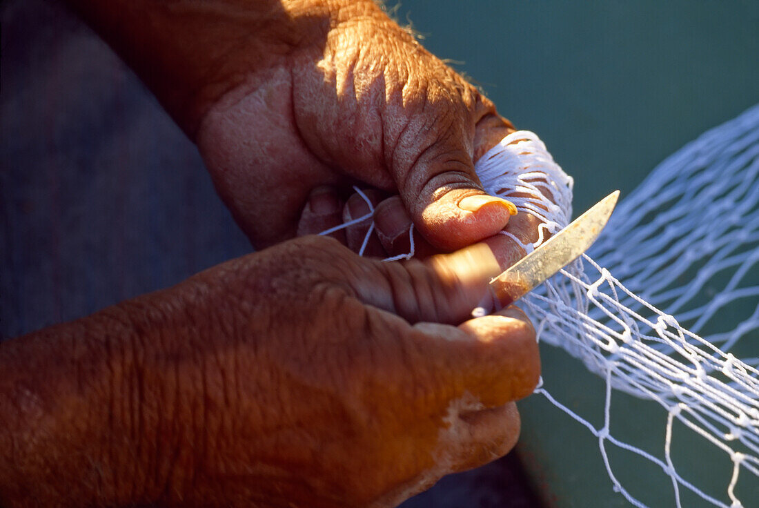 Fisherman mending a net,view of hands,Marsaxlokk,Malta Island,Republic of Malta