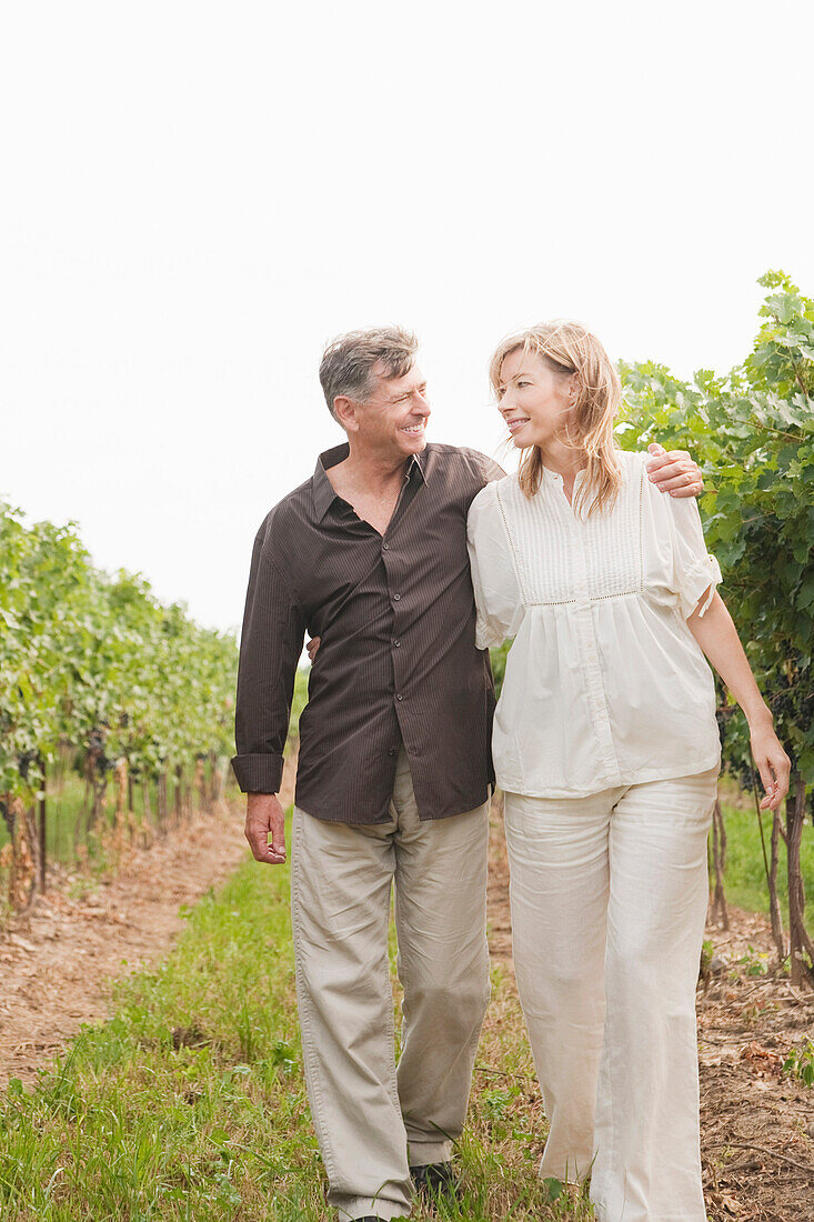 Couple Walking Through Vineyard