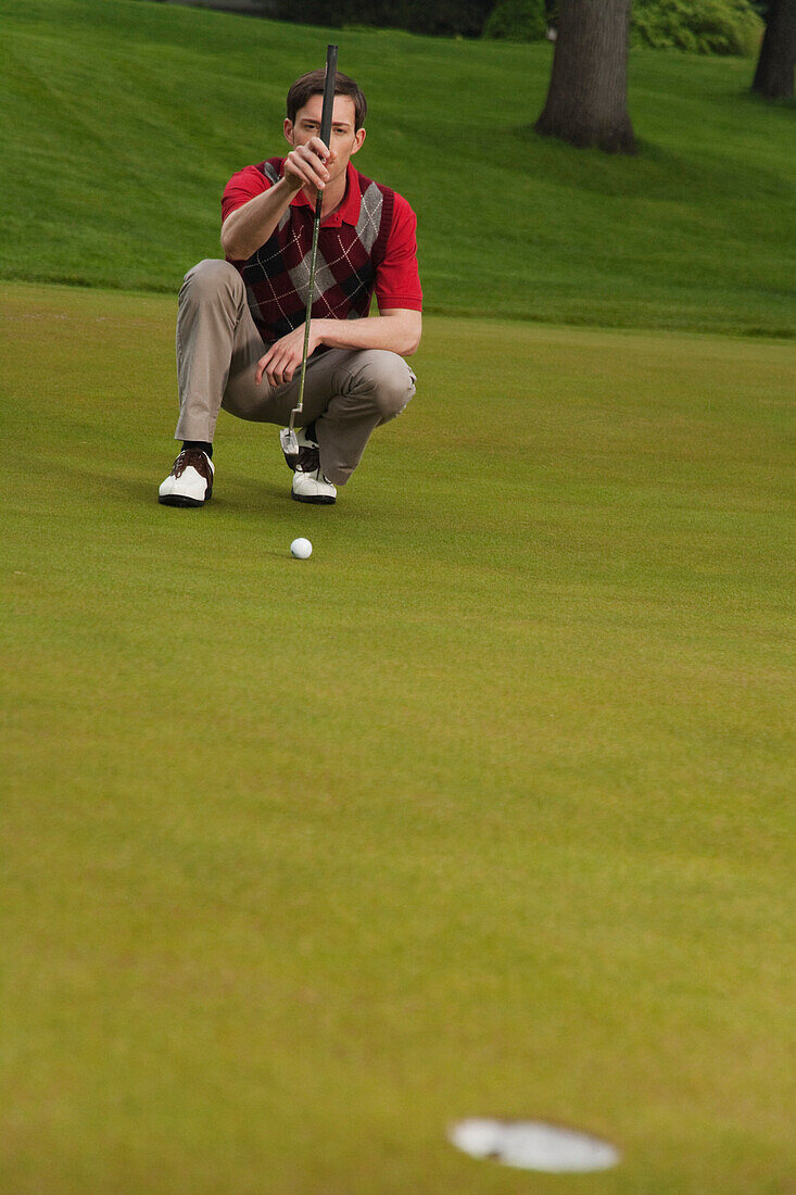 Man Assessing Golf Putt