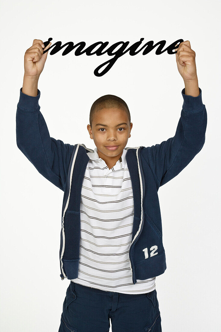 Boy Holding Imagine Sign