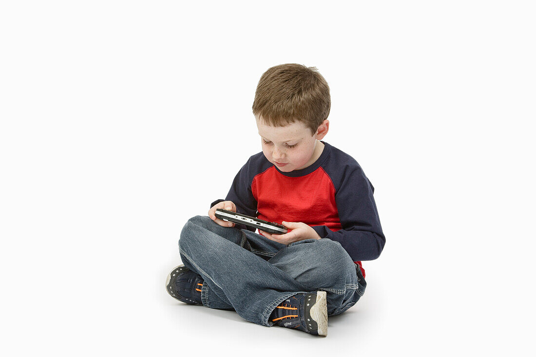 Boy Playing Handheld Video Game