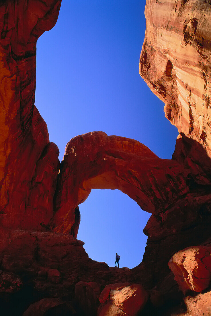 Hiker Under Double Arch Arches National Park Utah,USA