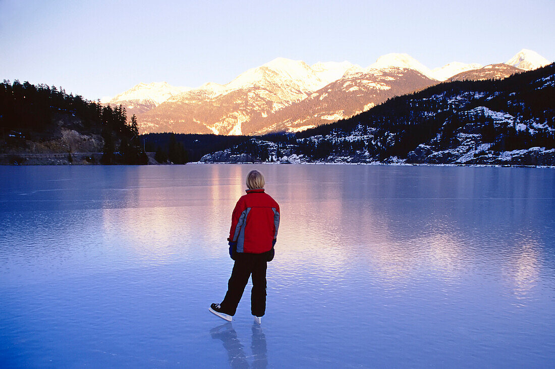 Boy Skating on Lake