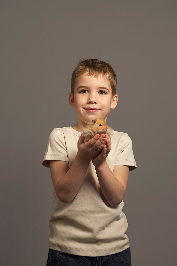 Little Boy Holding Hamster